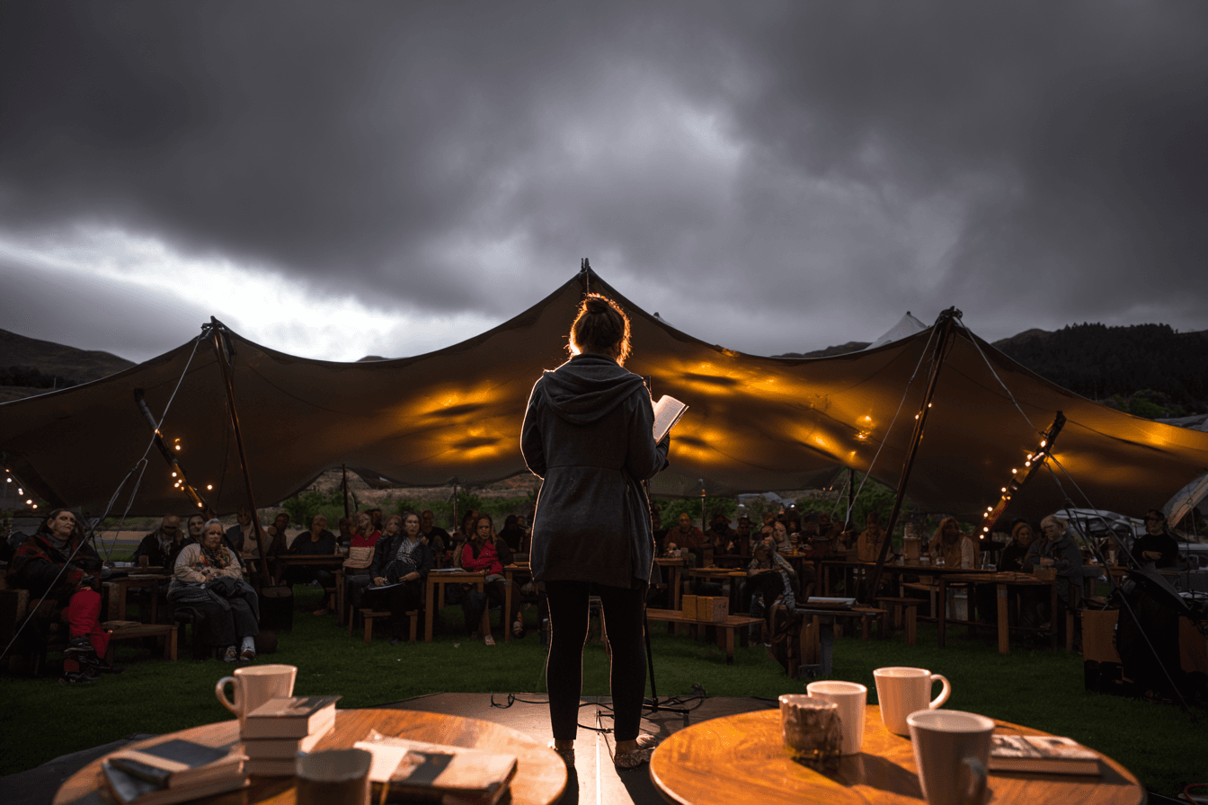 Author reading under a stretch tent at a Scottish literary festival